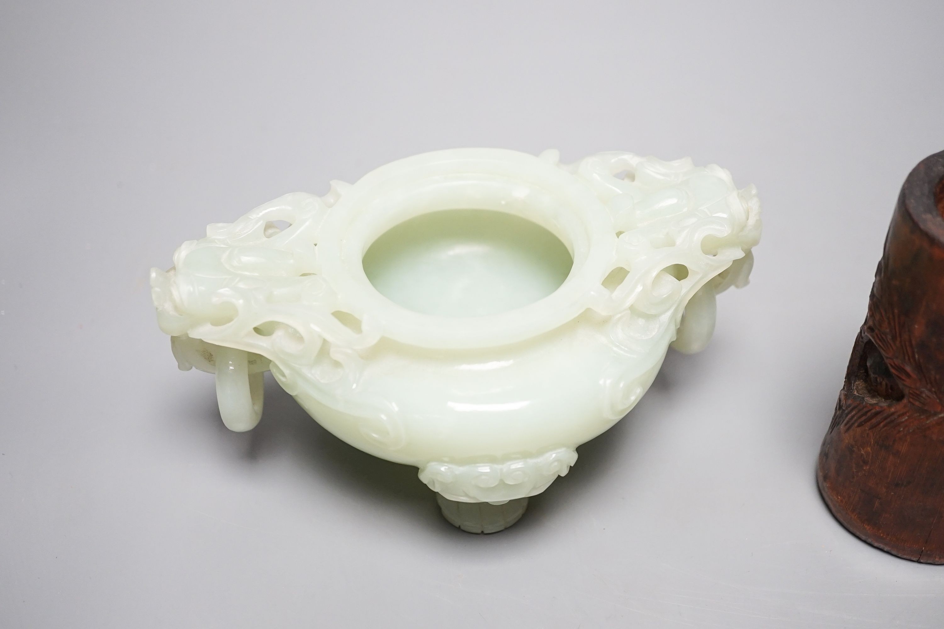 A Chinese bowenite jade tripod censer, 17cm wide, a Chinese green glazed ‘duck’ water dropper and a small bamboo brush part, 19th/20th century (3)